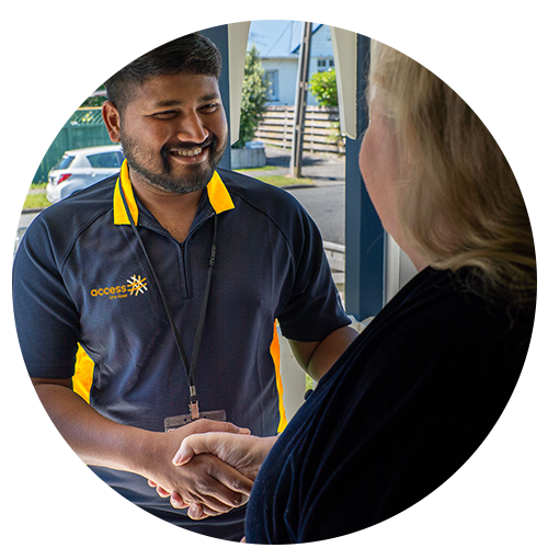Support worker and person shaking hands at the door